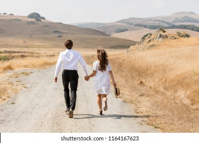 Road. Mountains. Couple   Holding Hands And Running Away In Mountains. Woman And Man In Love Walking Outdoors. Love Story