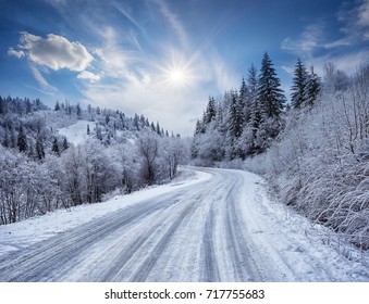 Road in the mountains covered with snow. Winter landscape. The concept of freedom and movement.