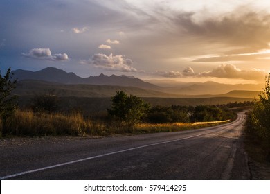 The road in the mountains at sunset - Shutterstock ID 579414295