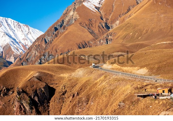 Road\
in the mountains. A truck is moving along the\
road.