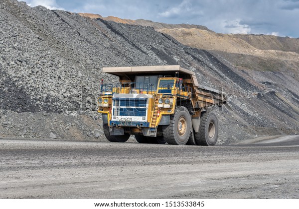 Road for the movement of heavy trucks.\
Mining truck is driving along a mountain road.\
