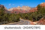 A road near Sedona, Arizona, with beautiful red rock mountains and desert trees in view, in Yavapai and Coconino Counties, near Clarkdale, Flagstaff, Cottonwood, and Village of Oak Creek, February 