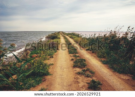 Road to nowhere - empty sand spit road through salt lake