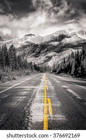 The road on Icefields parkway in Canadian Rockies in black & white with selective colorization and filtered style, Banff and Jasper NP