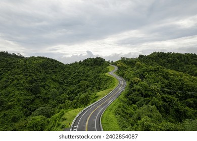 Road on mountain which a lot of road curve very popular landmark for tourist in Nan province, Thailand. - Powered by Shutterstock