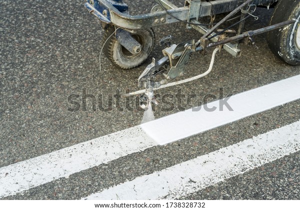 road painting and driving directions, road\
repair marking on asphalt\
pavement