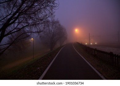Road in a park on foggy day next to railroad tracks - Powered by Shutterstock