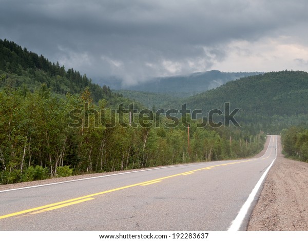 Road passing\
through forest, Quebec,\
Canada