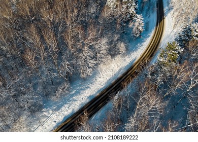 Road Passing Through A Snowy Forest, Aerial Landscape View