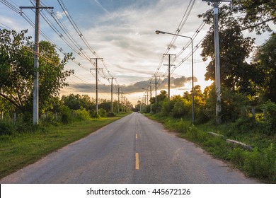 The road and power lines on sunset sky . - Powered by Shutterstock