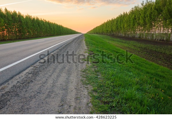 road receding into the distance, becomes a point\
on the horizon