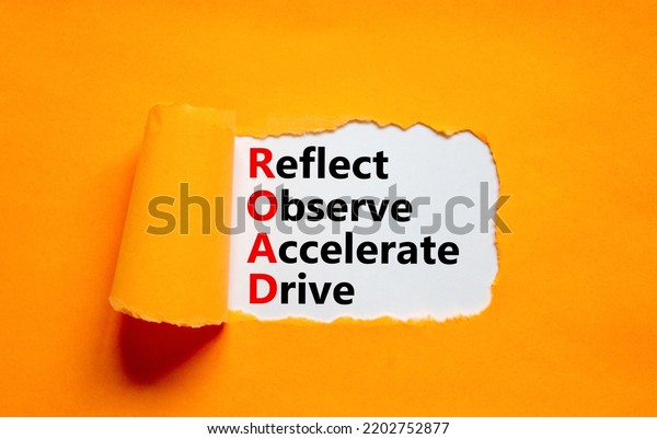 ROAD reflect observe accelerate drive symbol.\
Concept words ROAD reflect observe accelerate drive on white paper,\
orange background. Business ROAD reflect observe accelerate drive\
concept. Copy space.