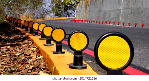 Road reflector beside a curved road,Traffic reflector,Road reflector        