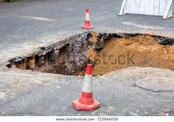 The road repair and caution with blocked barrier\
over concrete digging.