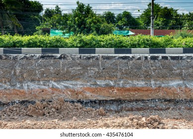Road repair with layer of materials to build road such as crushed rock, concrete, soil and asphalt