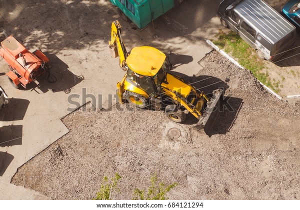 Road repair tractor\
removes old asphalt.