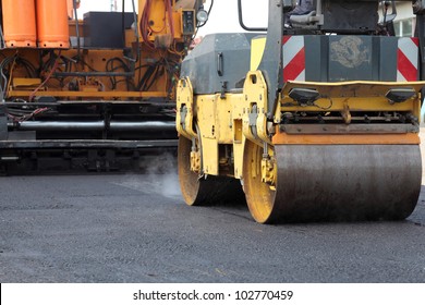 Road Roller And Asphalt Paving Machine At Construction Site