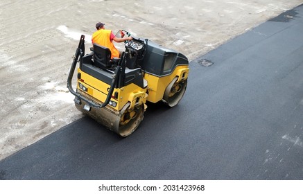 Road Roller Of An Asphalt Paving Machine At Work On Freshly Laid Tarmac.