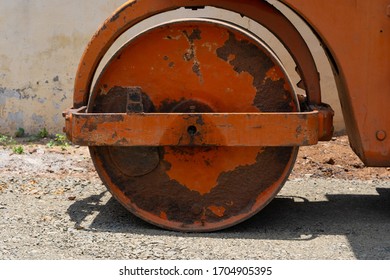 Road Roller Bull Dozer Big Red Circular Wheel With Rust Bright Sunny Day 