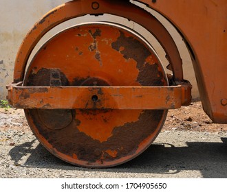 Road Roller Bull Dozer Big Red Circular Wheel With Rust Bright Sunny Day 