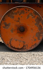 Road Roller Bull Dozer Big Red Circular Wheel With Rust Bright Sunny Day 