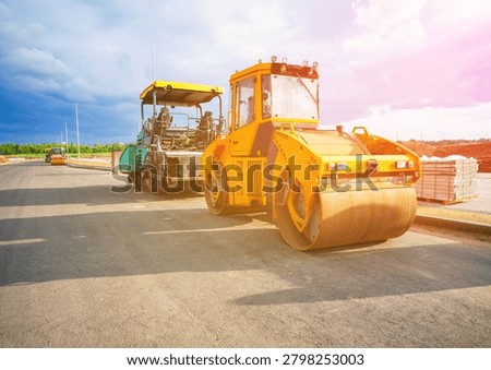 Road roller on asphalt road construction. Vibrator compactor machine on roadworks, asphalt pavement. Asphalt paving installation. Vibration roller on highway asphalting. Road compaction equipment. Special construction equipment for compact and smooth ground. Vibratory Roller, Double Drum or Tandem. 