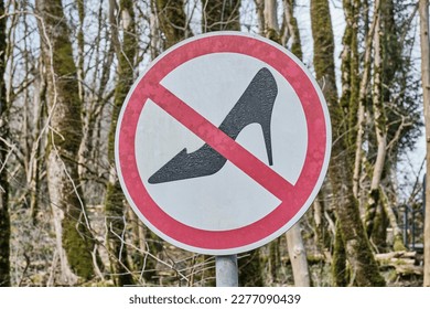 Road round sign indicating the prohibition of passage in women's shoes with heels, shoes that are uncomfortable for hiking. Installed in a park, nature reserve. - Shutterstock ID 2277090439