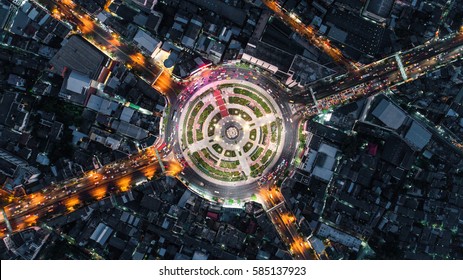 Road Roundabout With Car Lots Wongwian Yai In Bangkok,Thailand. Street Large Beautiful Downtown At Night Light.  Aerial View , Top View ,cityscape ,Rush Hour Traffic Jam