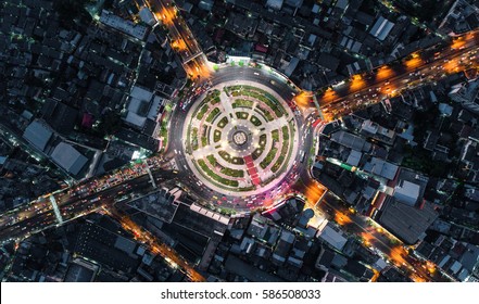 Road Roundabout With Car Lots Wongwian Yai In Bangkok,Thailand. Street Large Beautiful Downtown At Night Light.  Aerial View , Top View ,cityscape ,Rush Hour Traffic Jam