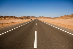 Road In The Sahara Desert Of Egypt. Conceptual For Freedom, Enjoying The Journey. Empty Road. Freeway, Highway Through The Desert
