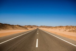 Road In The Sahara Desert Of Egypt. Conceptual For Freedom, Enjoying The Journey. Empty Road. Freeway, Highway Through The Desert