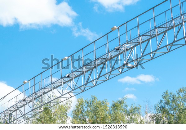 Road security cameras on a\
metal beam against a blue sky. Security system on a suburban\
highway