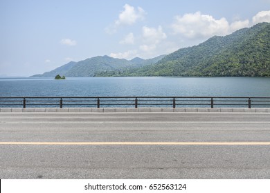 Road Side View Mountain And Sea Background