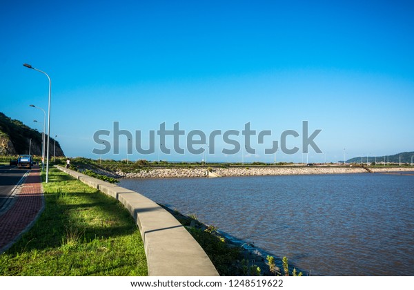 Road side view\
mountain and sea\
background