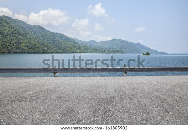Road side view\
mountain and sea\
background