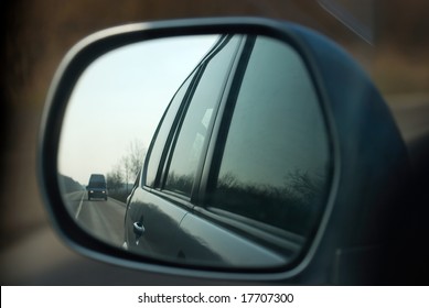 Road In The Sideview Mirror Of A Car