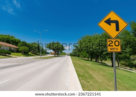 road sign of 20 mph and turning signal. caution yellow roadsign. traffic sign on the road. attention caution road sign. mph and turn signal