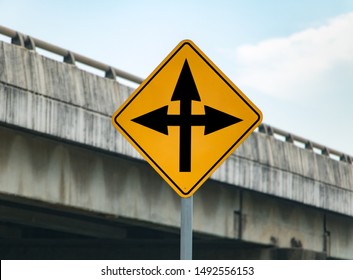 Road Sign With Arrows Informs About Crossing On The Road. Warning Of Junction With Change Course.