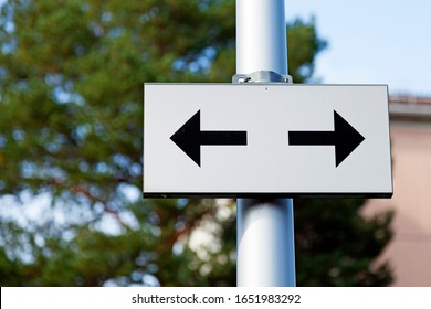 Road Sign With Arrows In Two Different Directions