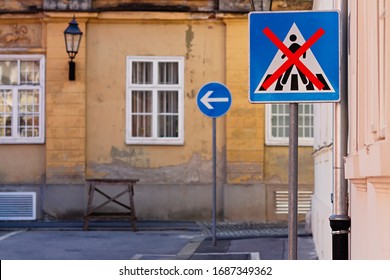 Road Sign With Big Red X Forbidding People To Walk Here, In Front Of An Old City Street