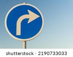 Road sign blue right turn signal on sky background