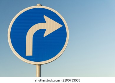 Road sign blue right turn signal on sky background - Shutterstock ID 2190733033