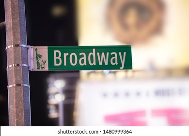 Road Sign and Broadway Avenue Behind