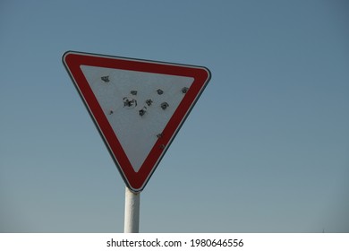 Road Sign With Bullet Holes Close Up.