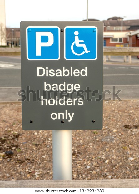 Road sign in car park showing bay reserved for\
holders of a Disabled Badge\
only