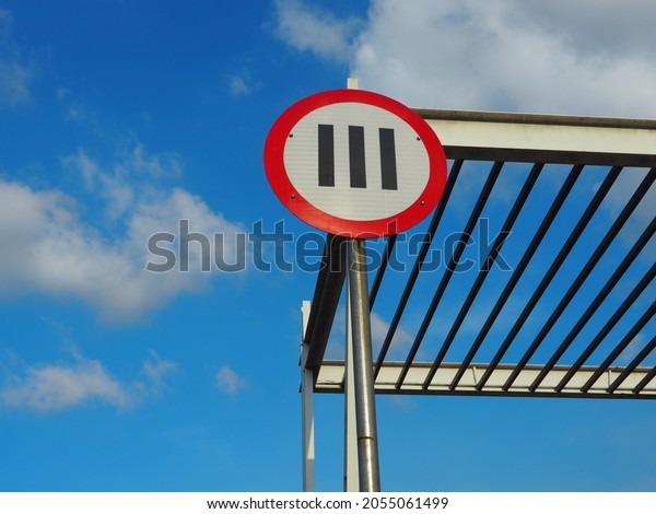 Road sign\
with clear bright blu sky on sunny\
day.