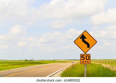 Road sign displaying the maximum speed of 50 mph and that it is a curvy road in the Flint Hills region in Kansas.