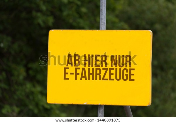Road sign and German translation for only\
electronic cars from this\
place