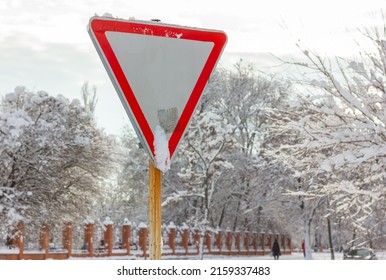 Road Sign Give Way. Snow Covered City.