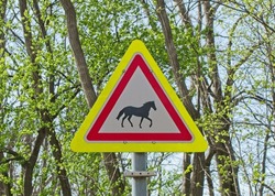 Road Sign With The Image Of A Horse. Sign Caution Horse And Rider Crossing. Road Sing Of Hungary, Europe. 